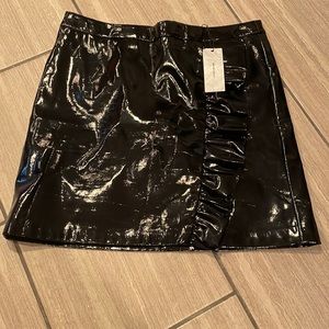 Patten leather skirt with ruffle accent
